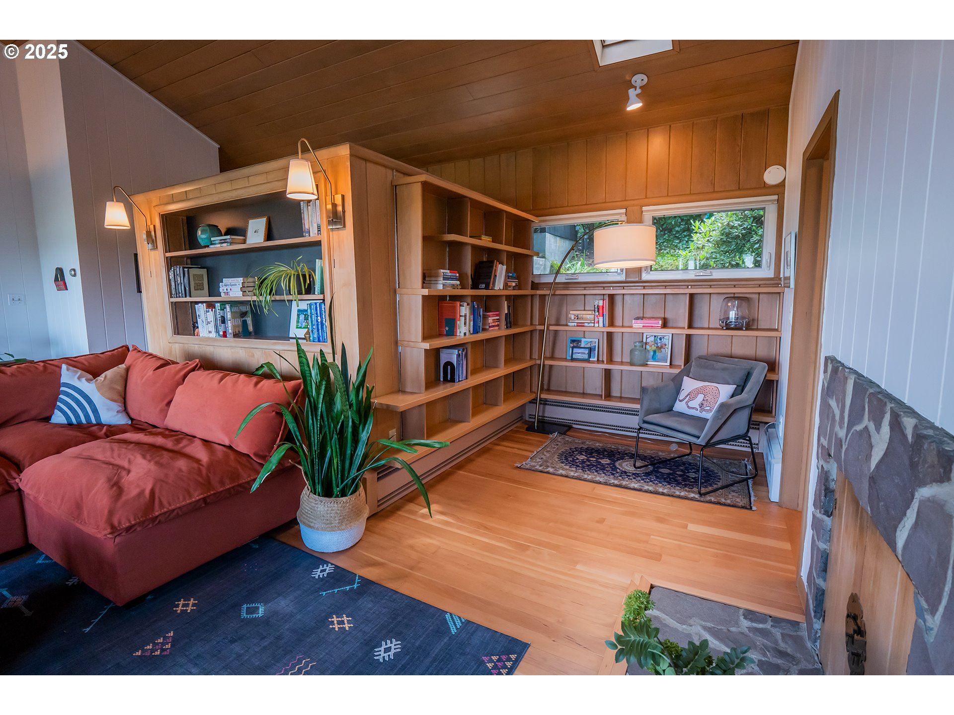 275 Sunset Drive Eugene, OR 97403 - Photo 5 of 45 a living room with furniture a bookshelf and a potted plant