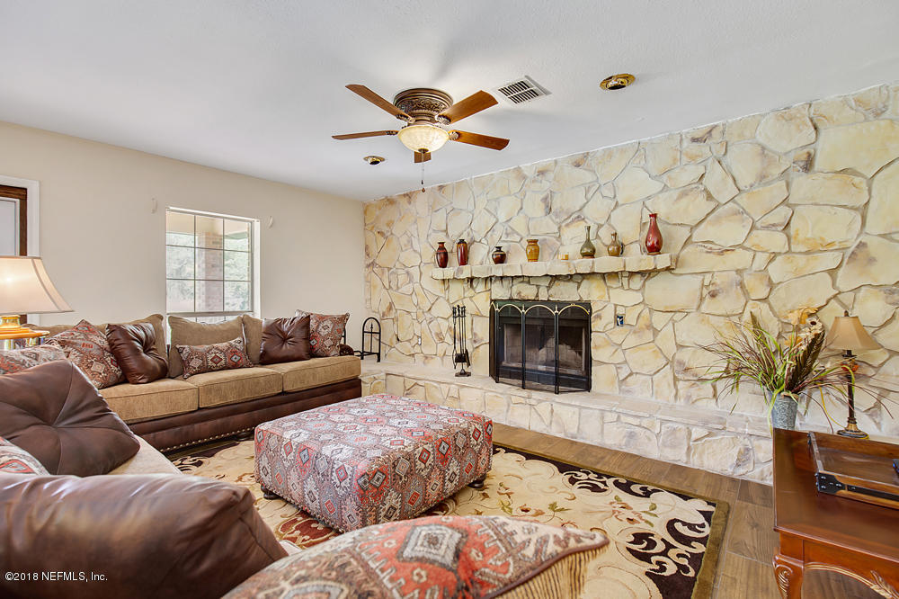 541103 Lem Turner Road Callahan, FL 32011 - Photo 13 of 58 a living room with furniture and a fireplace