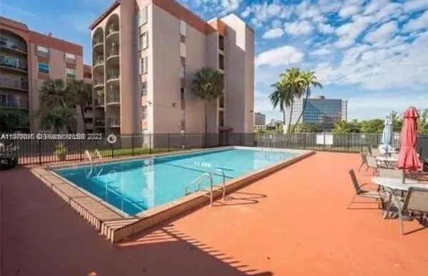 a swimming pool with outdoor seating and yard