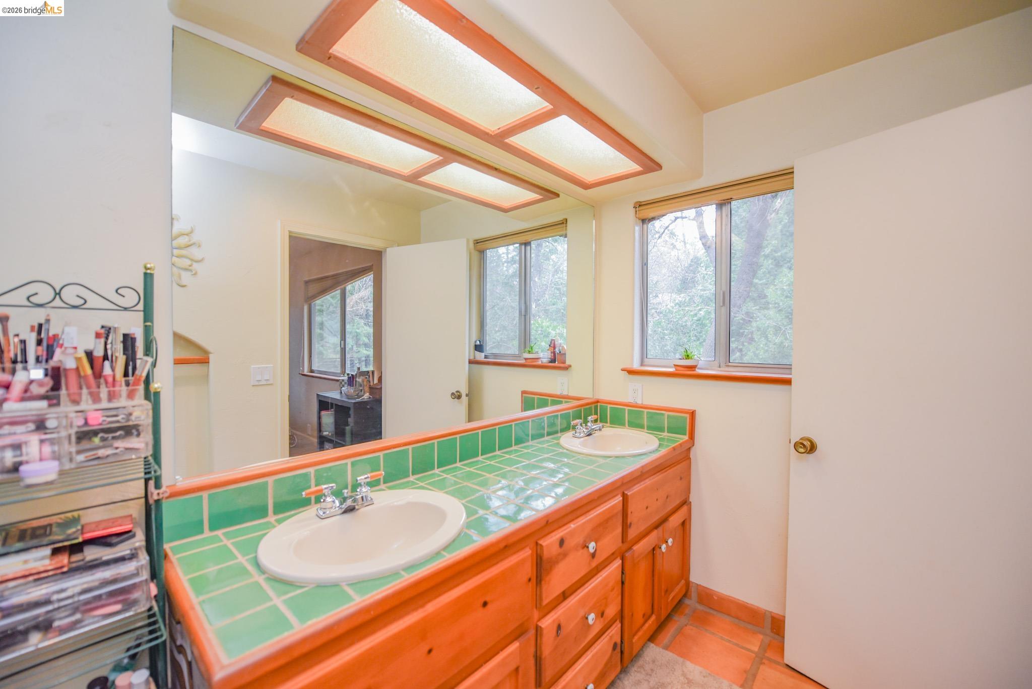 24132 Awahanee Road Sonora, CA 95370 - Photo 18 of 39 a bathroom with a granite countertop sink and a large mirror