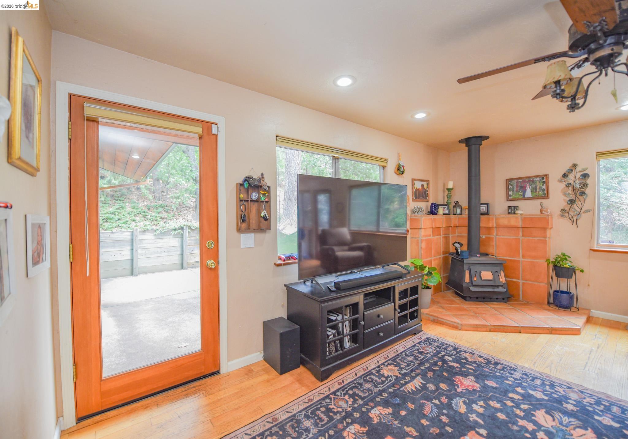24132 Awahanee Road Sonora, CA 95370 - Photo 3 of 39 a living room with furniture a flat screen tv and a floor to ceiling window