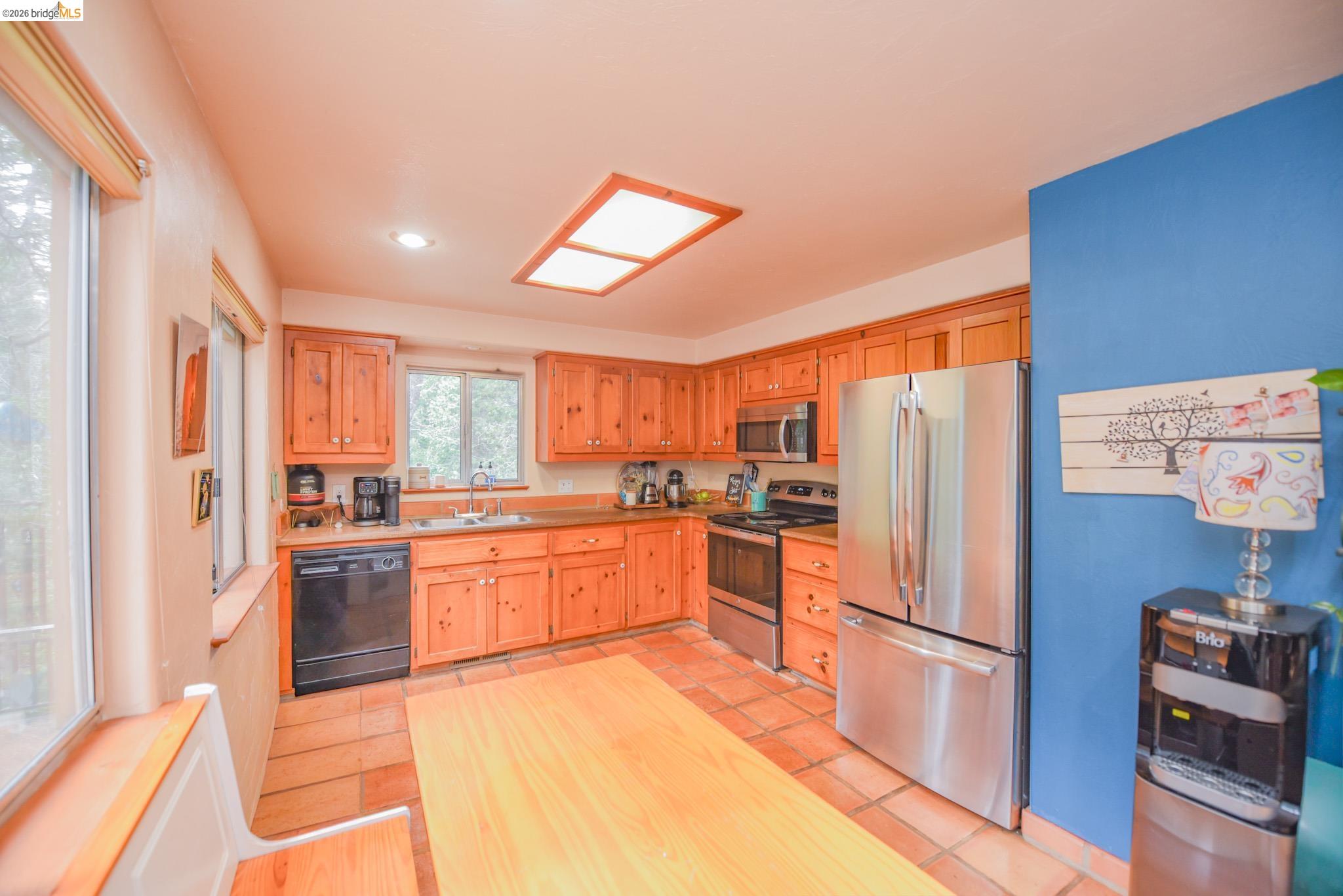 24132 Awahanee Road Sonora, CA 95370 - Photo 7 of 39 a kitchen with stainless steel appliances a refrigerator sink and stove