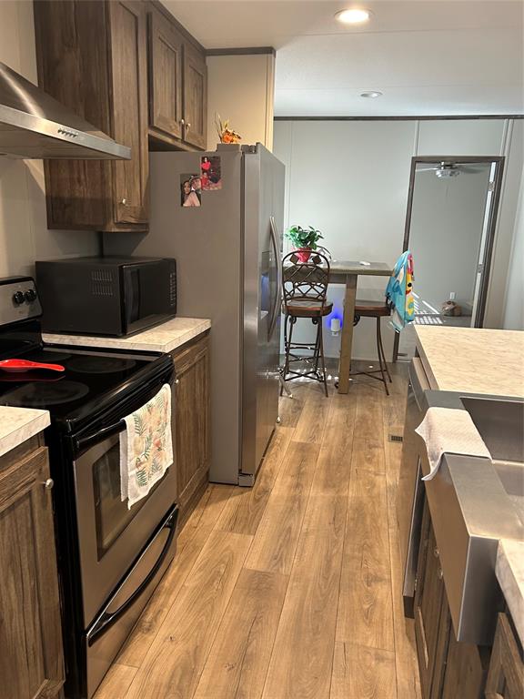 241 County Road 2168 Quitman, TX 75783 - Photo 3 of 11 a kitchen with granite countertop a stove a sink and a refrigerator