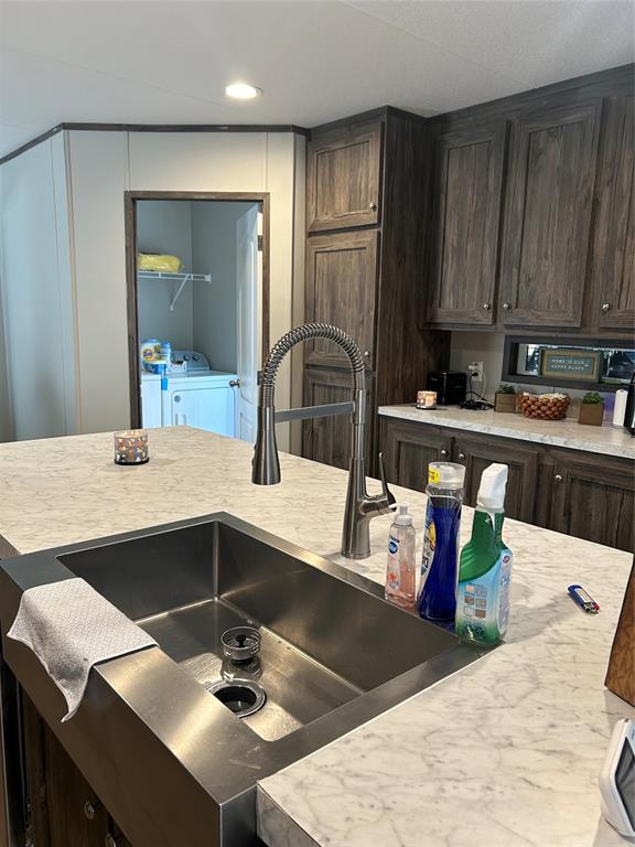 241 County Road 2168 Quitman, TX 75783 - Photo 4 of 11 a kitchen with a sink a stove and cabinets