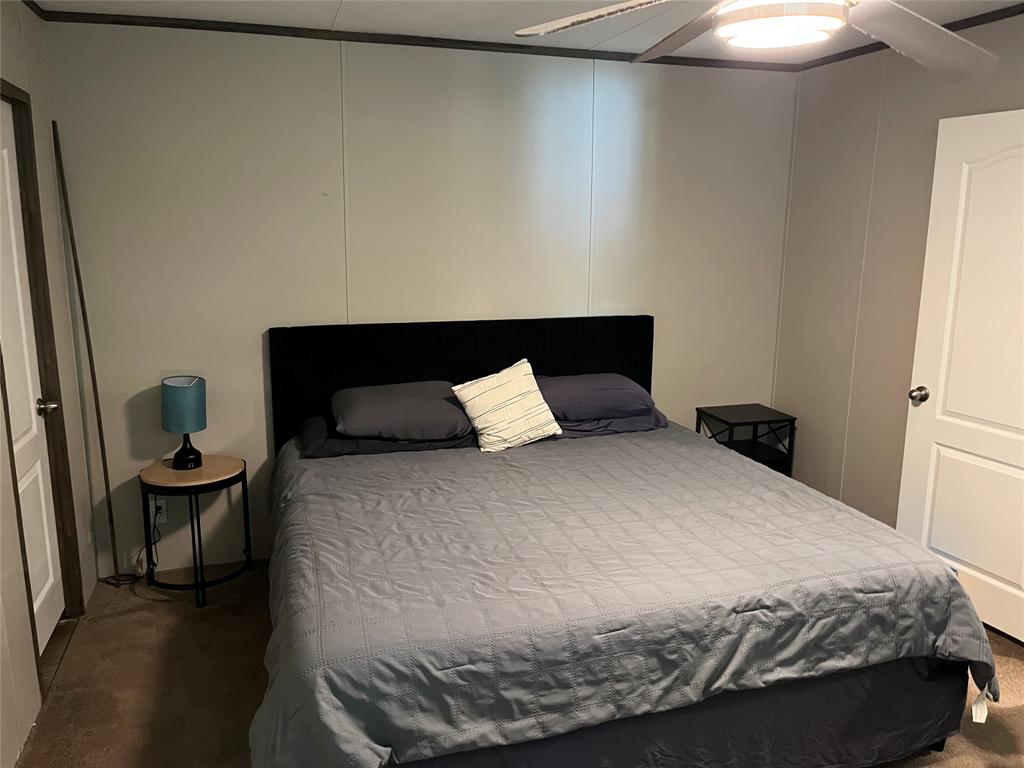 241 County Road 2168 Quitman, TX 75783 - Photo 6 of 11 a bedroom with a bed and a lamp