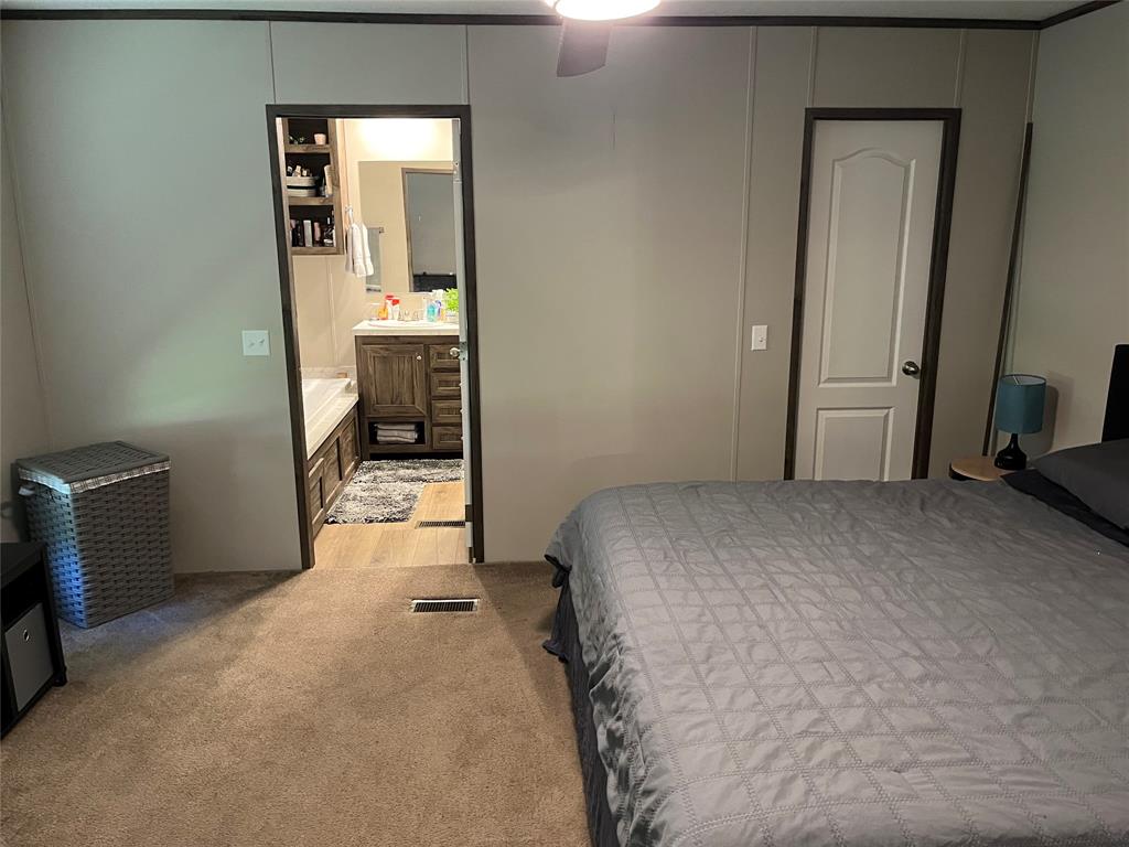 241 County Road 2168 Quitman, TX 75783 - Photo 7 of 11 a room that has a bed and a mirror in it