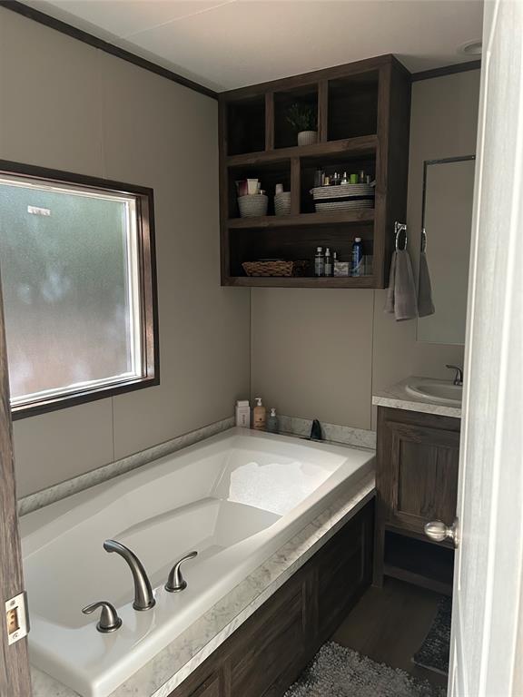 241 County Road 2168 Quitman, TX 75783 - Photo 8 of 11 a bathroom with a sink and a bathtub