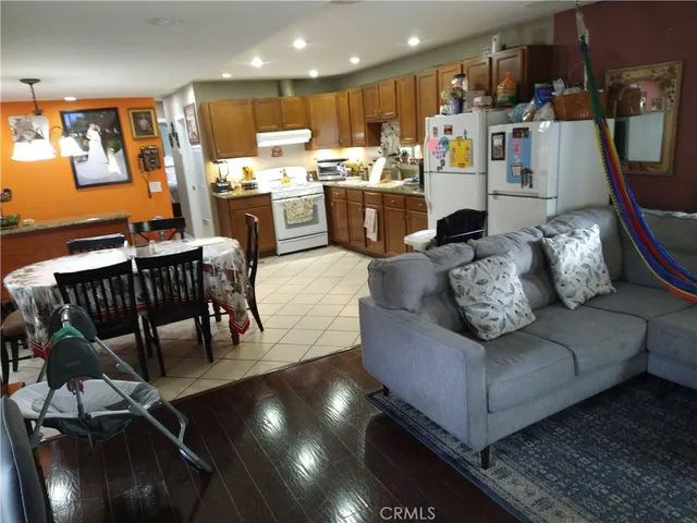 a living room with lots of furniture and kitchen view