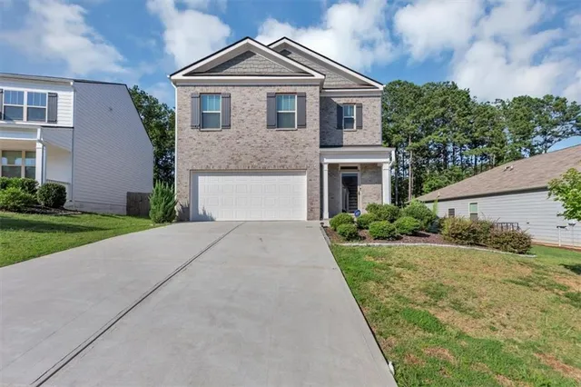 a front view of a house with a yard