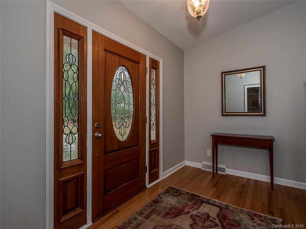 3437 High Ridge Road Charlotte, NC 28270 - Photo 3 of 23 a view of an entryway with wooden floor mirror and a door
