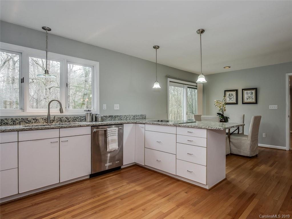 3437 High Ridge Road Charlotte, NC 28270 - Photo 8 of 23 a kitchen with sink cabinets and wooden floor