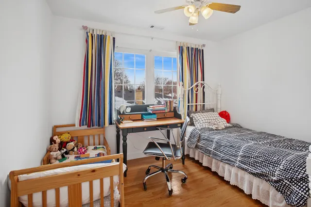 a living room with baby crib furniture and a window