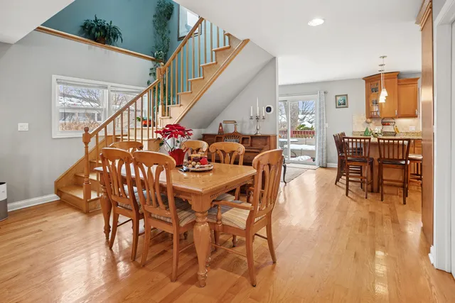 a dining room with furniture entryway and wooden floor