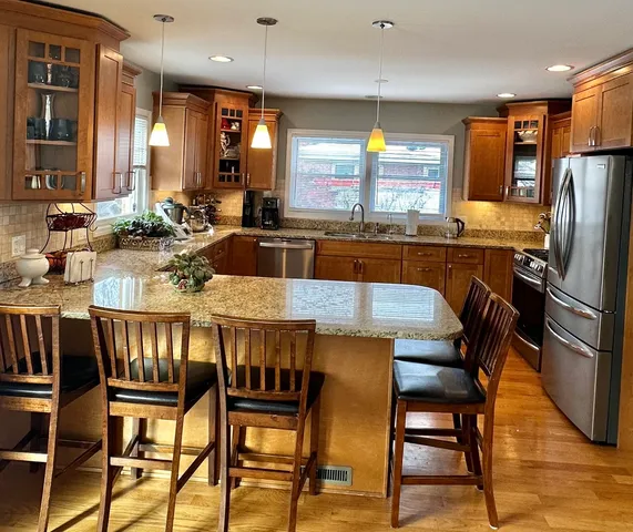 a large kitchen with a table and chairs