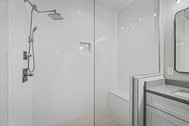 a bathroom with a shower and cabinets