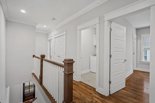 a view of a hallway with wooden floor