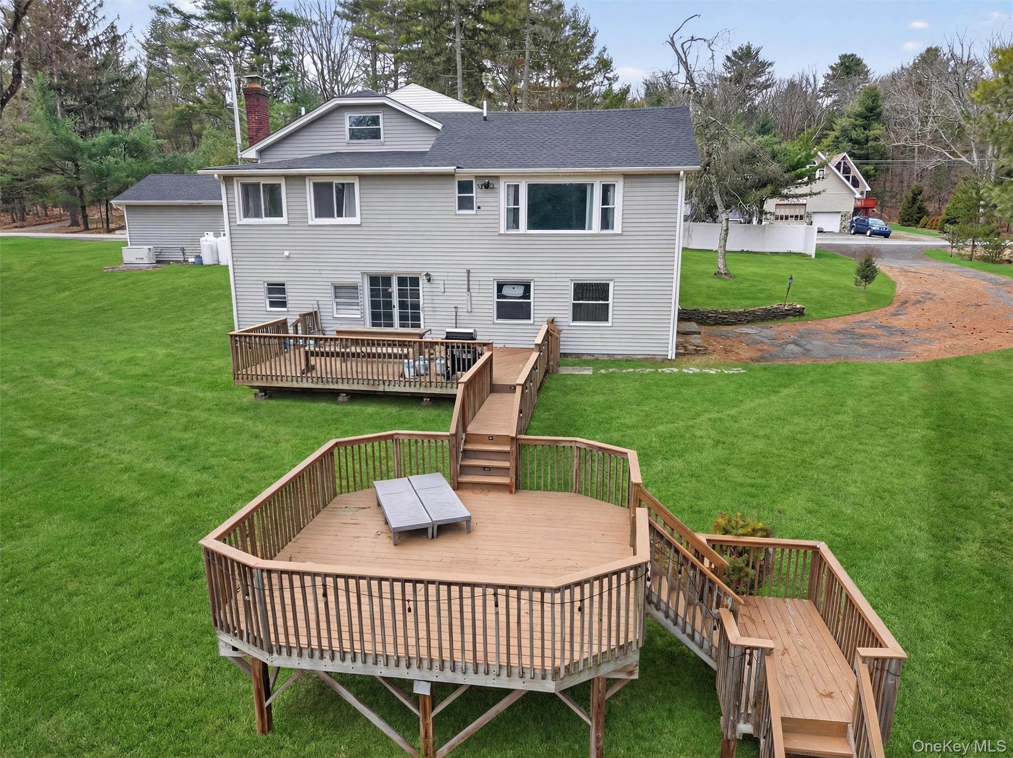 86 Beaver Brook Road Narrowsburg, NY 12764 - Photo 42 of 48 a view of a house with a deck and a yard