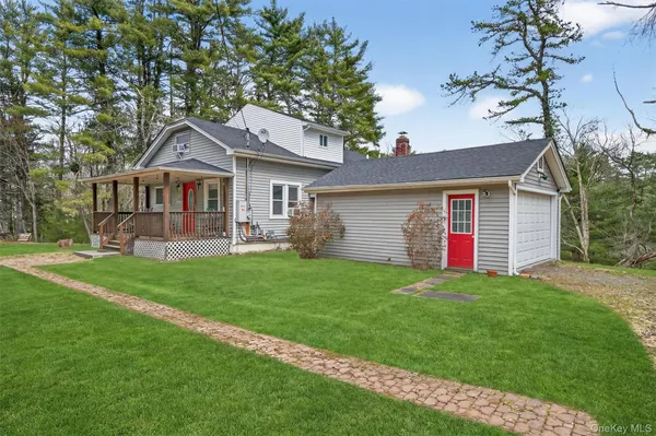 a front view of a house with a yard and trees