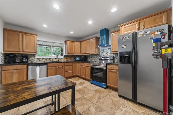 a kitchen with kitchen island a stove a sink and a refrigerator