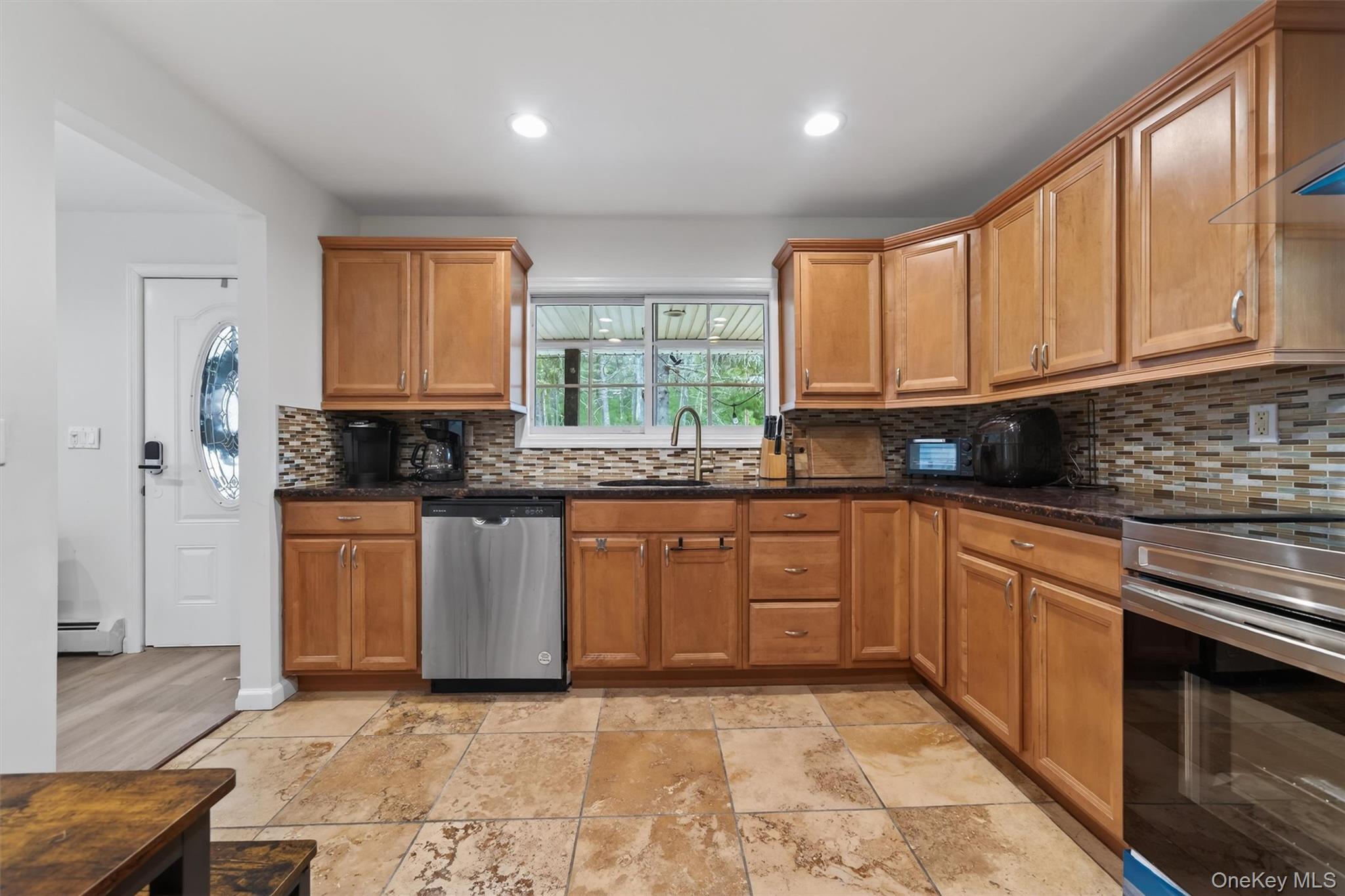 86 Beaver Brook Road Narrowsburg, NY 12764 - Photo 10 of 48 a kitchen with stainless steel appliances granite countertop a stove a sink and a microwave