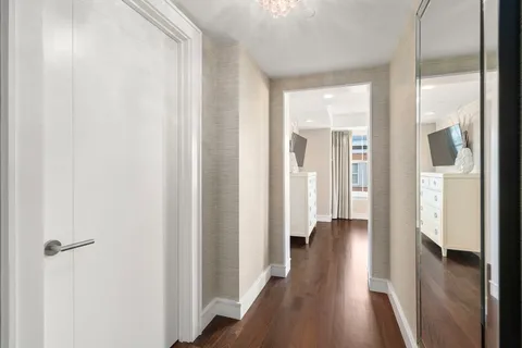 a view of a hallway with wooden floor