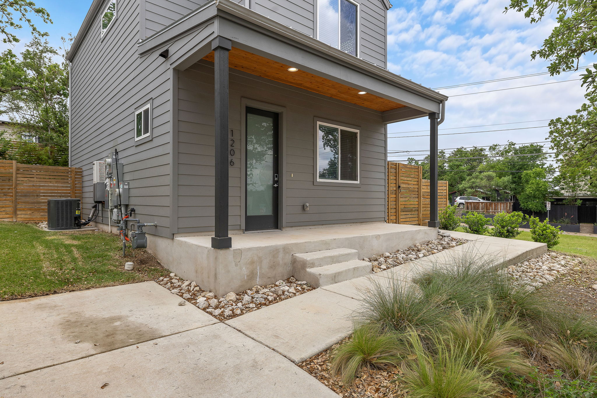 1206 Sarabeth Way Austin, TX 78721 - Photo 3 of 27 Doorway to property featuring central AC, fence, and a porch