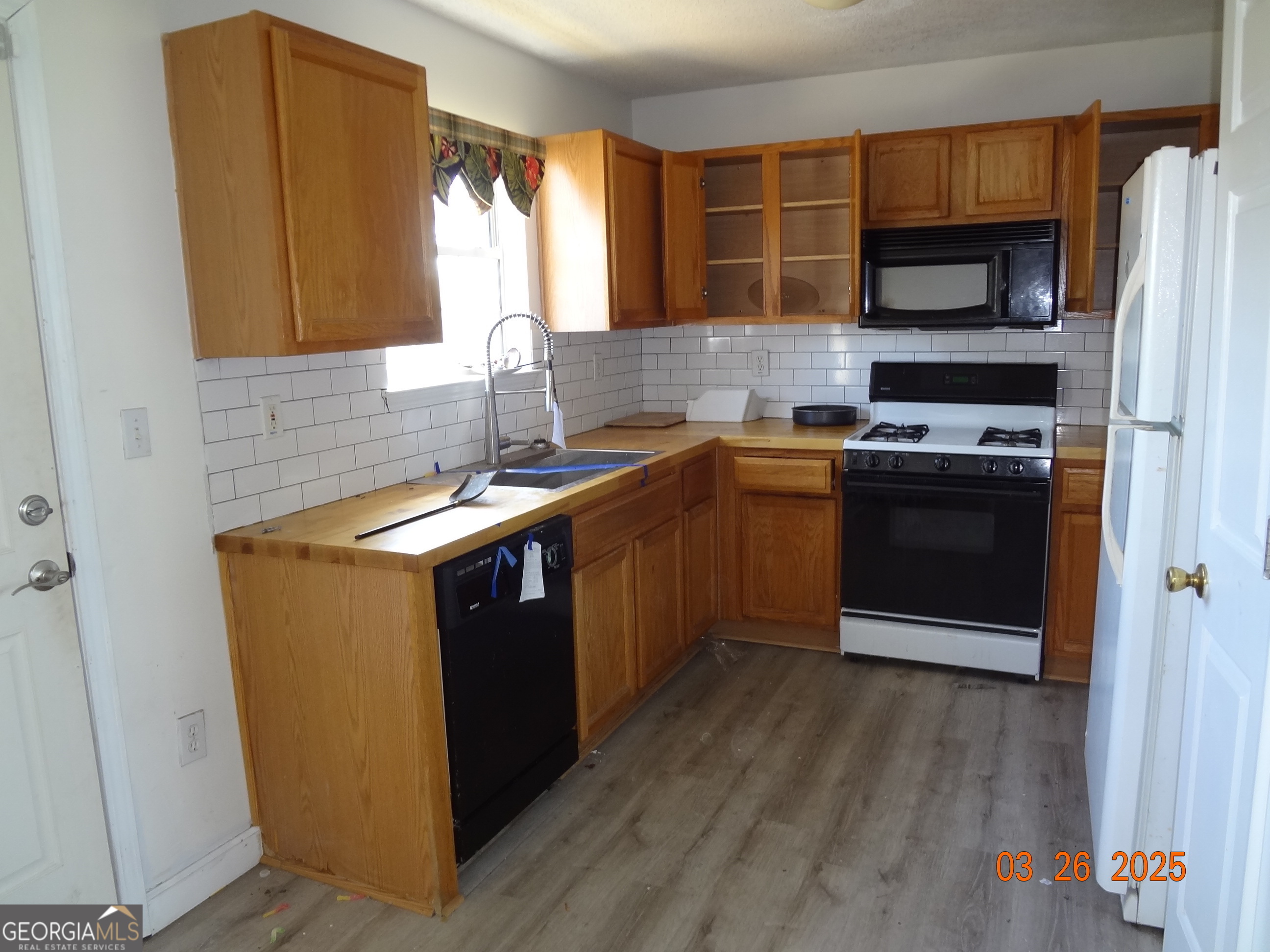 2338 Rambling Way Lithonia, GA 30058 - Photo 11 of 16 a kitchen with stainless steel appliances granite countertop a stove a sink and a refrigerator