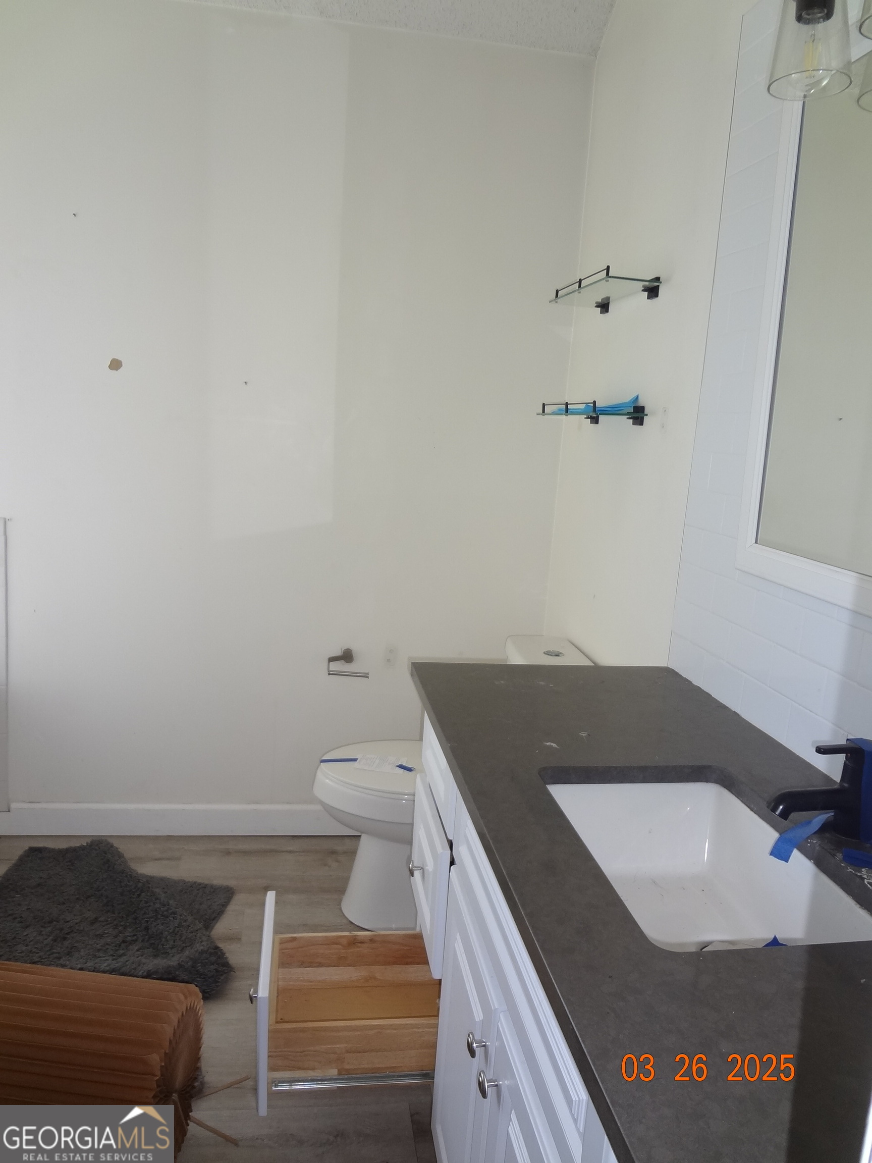 2338 Rambling Way Lithonia, GA 30058 - Photo 14 of 16 a bathroom with a granite countertop sink and a vanity