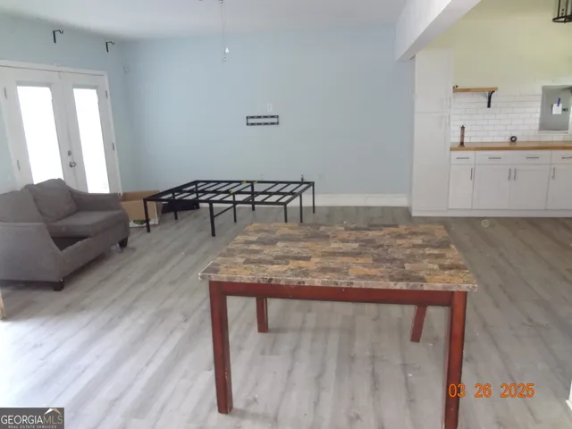 a living room with furniture and wooden floor