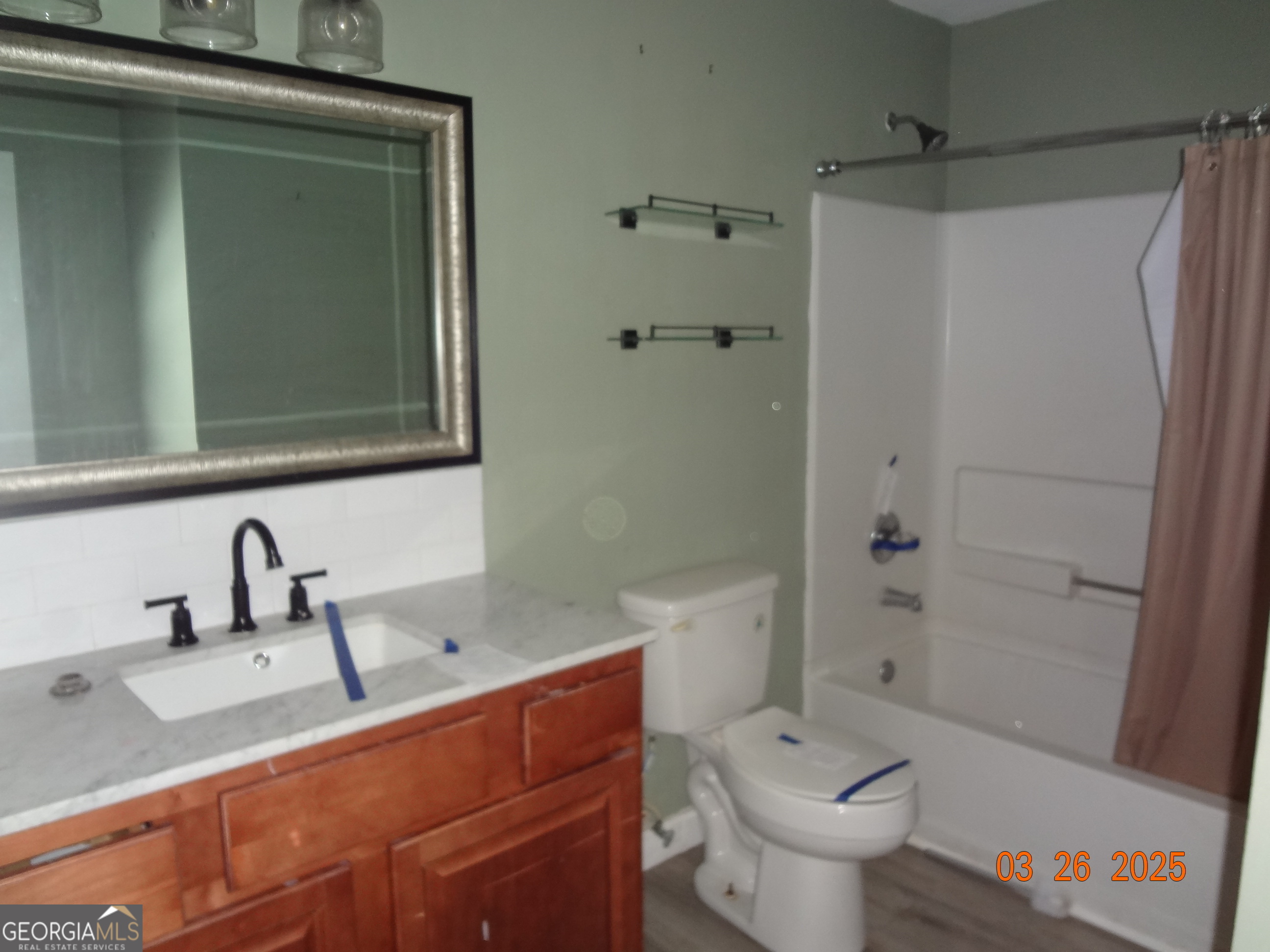 2338 Rambling Way Lithonia, GA 30058 - Photo 5 of 16 a bathroom with a sink a toilet and shower