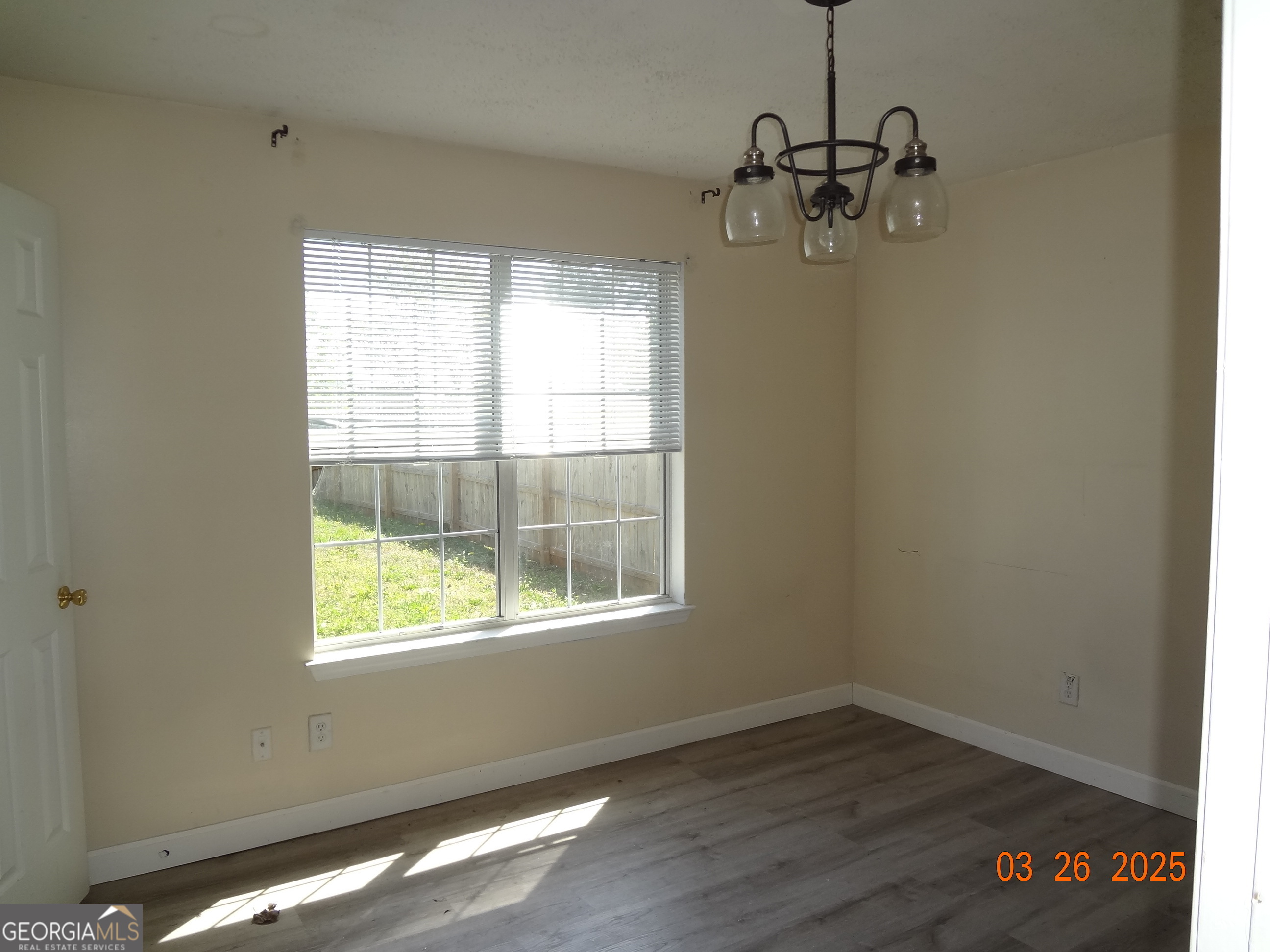 2338 Rambling Way Lithonia, GA 30058 - Photo 6 of 16 wooden floor in an empty room with a window