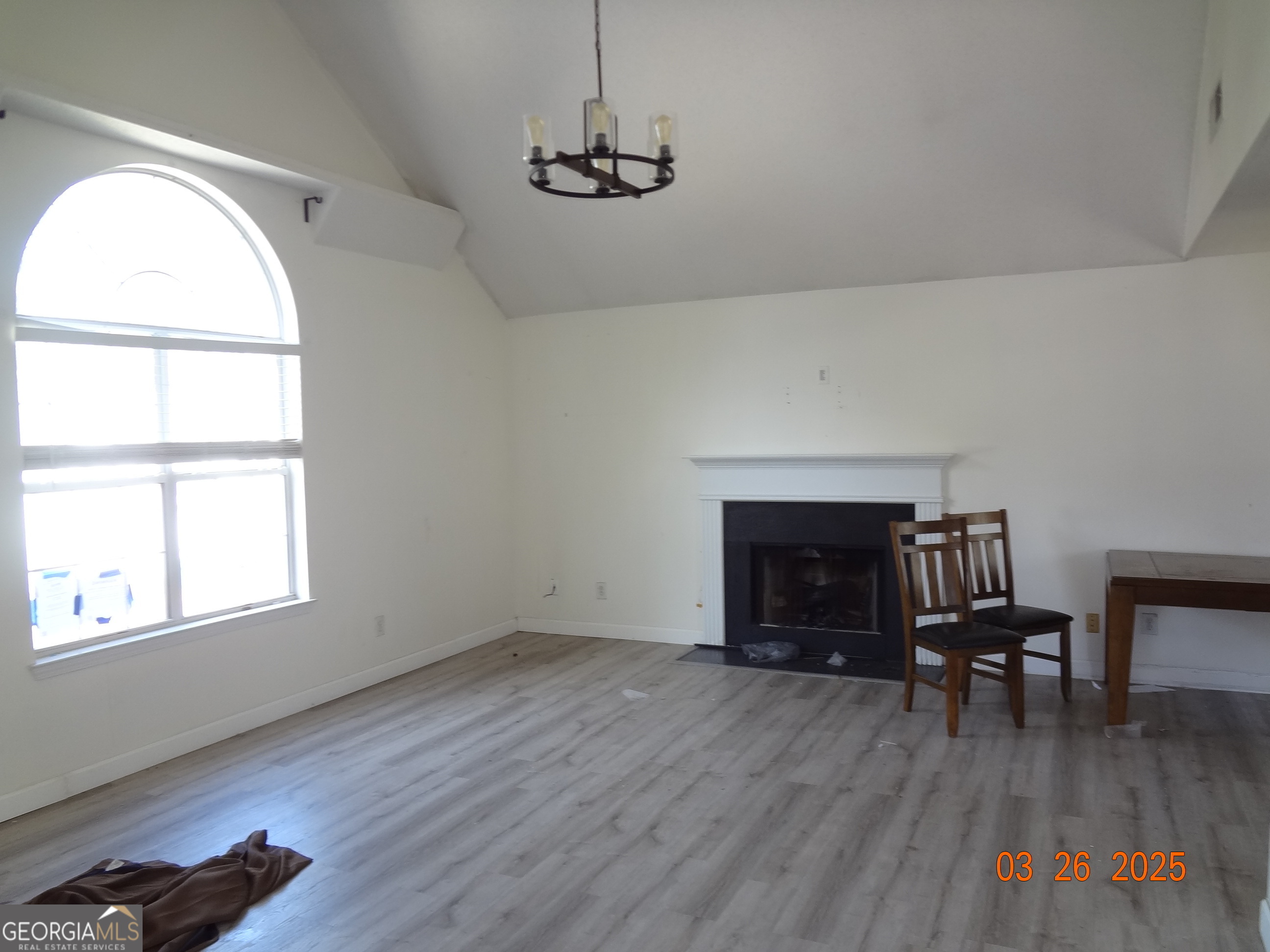 2338 Rambling Way Lithonia, GA 30058 - Photo 9 of 16 an empty room with wooden floor fireplace and windows