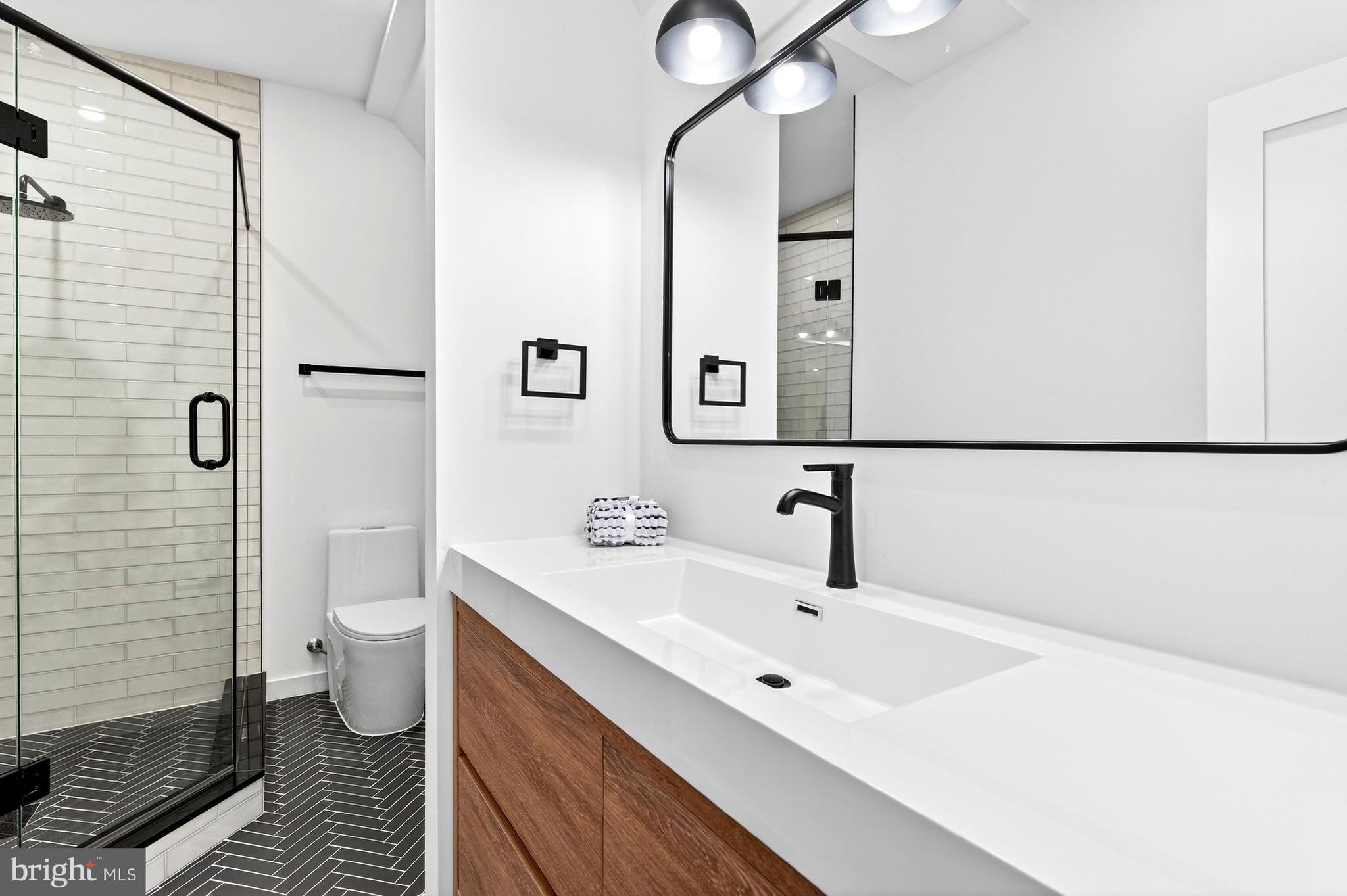 7126 Darby Road Bethesda, MD 20817 - Photo 58 of 84 a bathroom with a double vanity sink toilet and shower