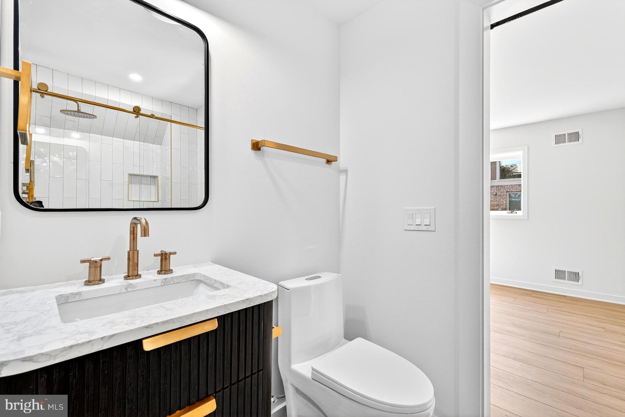 7126 Darby Road Bethesda, MD 20817 - Photo 67 of 84 a bathroom with a granite countertop sink vanity mirror and toilet
