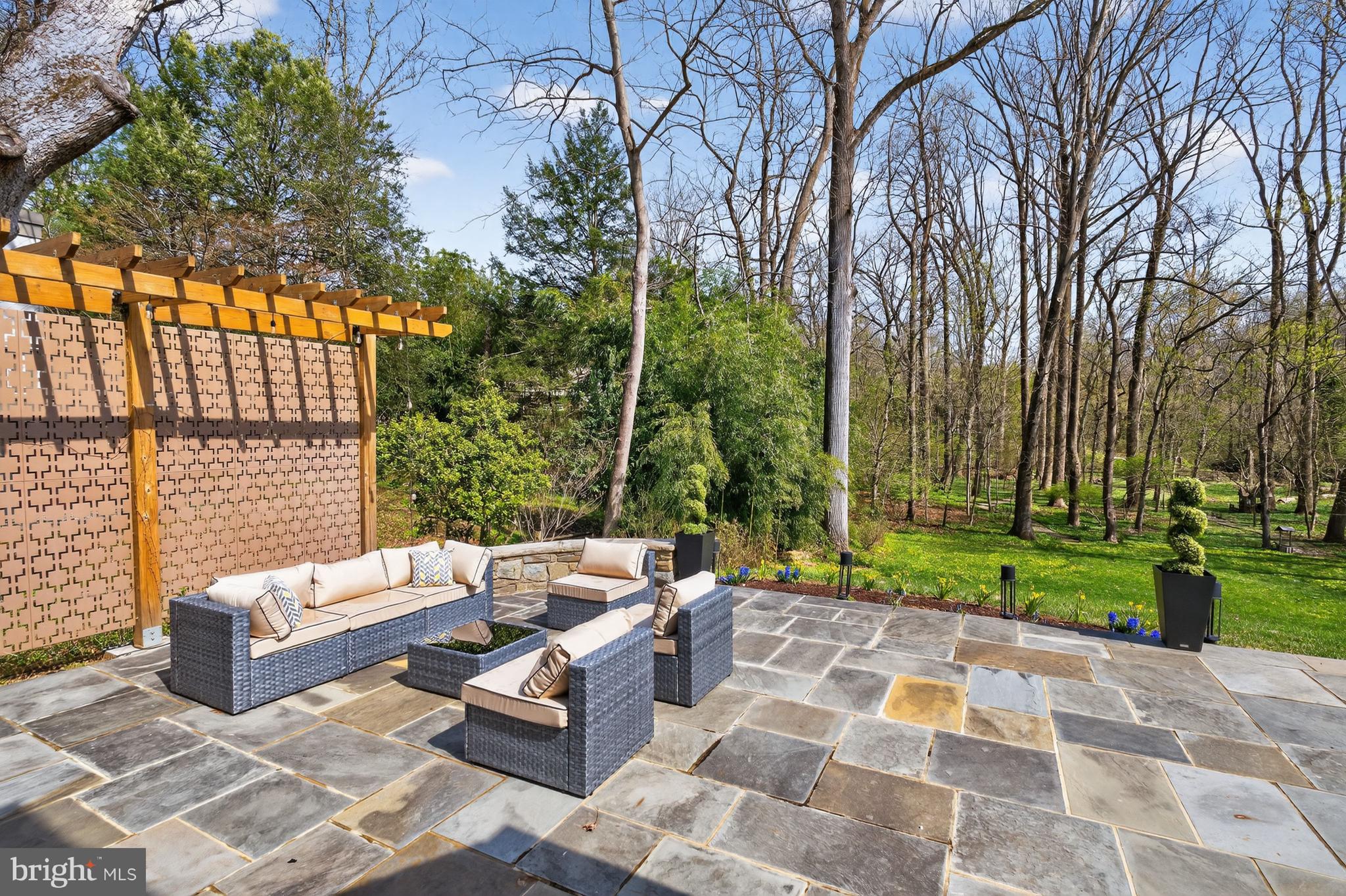 7126 Darby Road Bethesda, MD 20817 - Photo 73 of 84 a view of a patio with couches and chairs under an umbrella