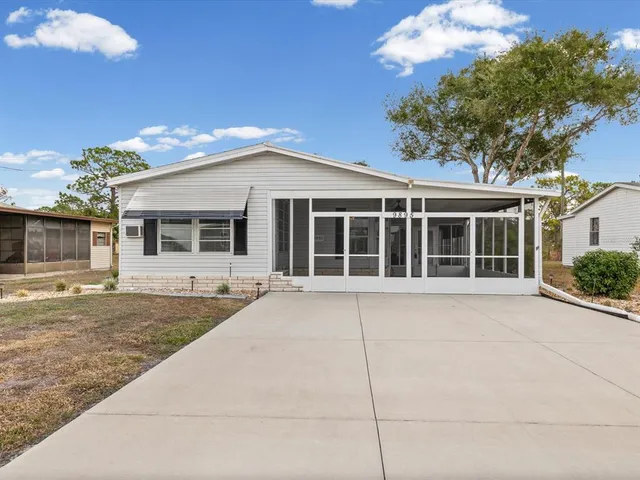 a front view of a house with a garden and yard
