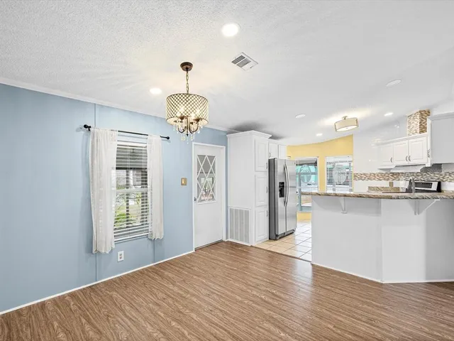 a kitchen with granite countertop a sink stainless steel appliances and cabinets