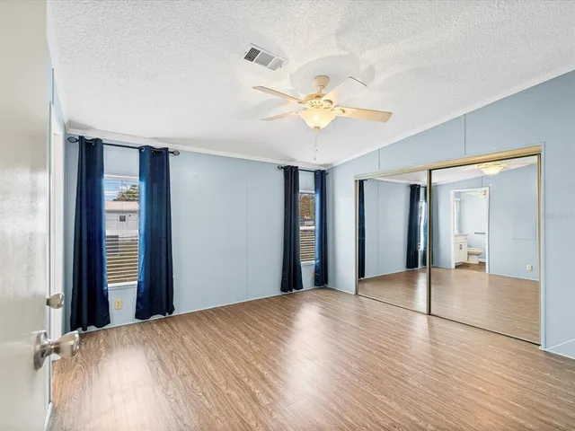 wooden floor in an empty room with a mirror