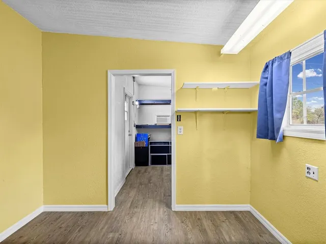 a view of walk in closet with empty racks