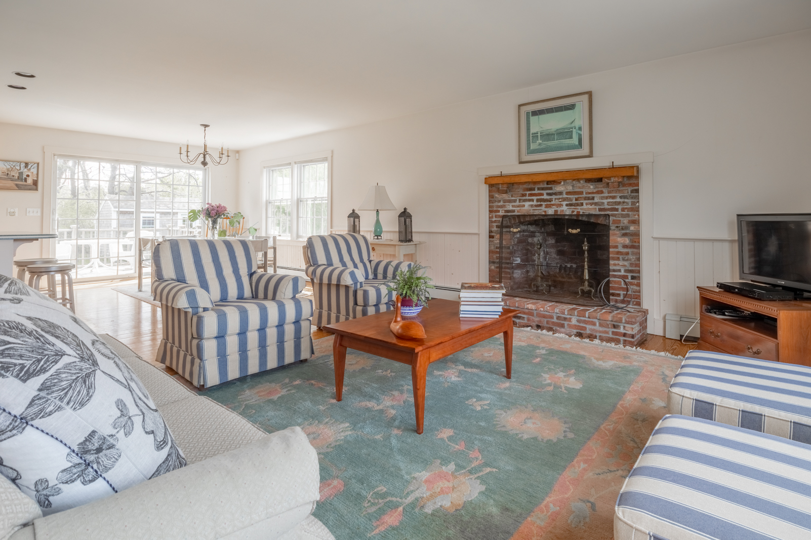 15 Swift Rock Road Nantucket, MA 02554 - Photo 9 of 32 a living room with furniture a flat screen tv and a fireplace