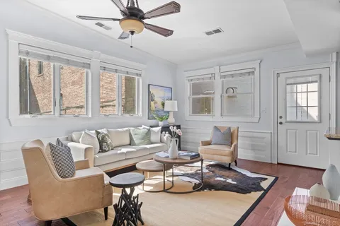 a living room with furniture and wooden floor