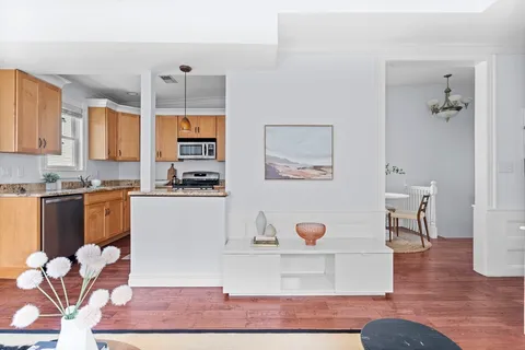 a kitchen with stainless steel appliances granite countertop a refrigerator and a stove top oven