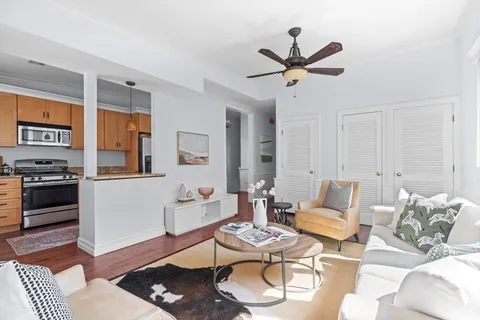 a living room with furniture and kitchen view