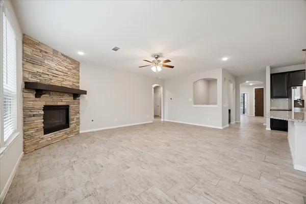 a view of an empty room with a fireplace