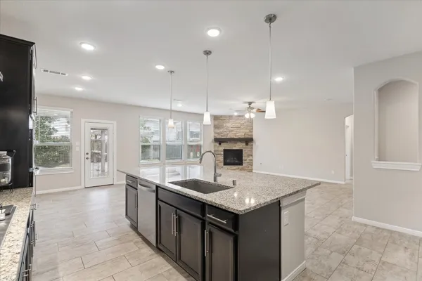 a kitchen with granite countertop a sink and stove