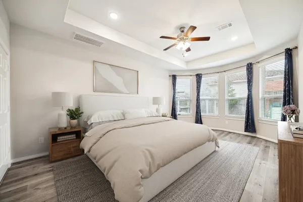 a spacious bedroom with a large bed and a large window