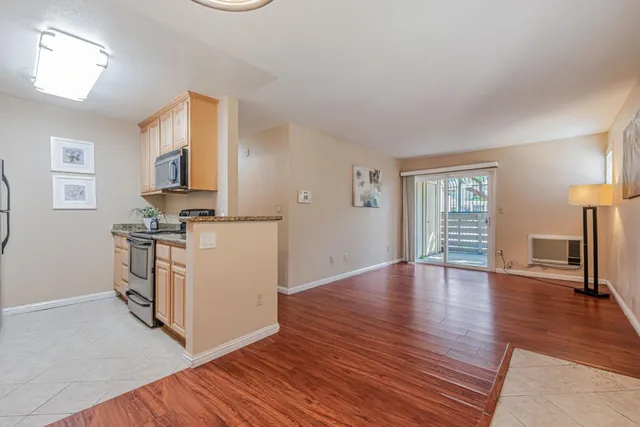 a view of kitchen with stove and wooden floor