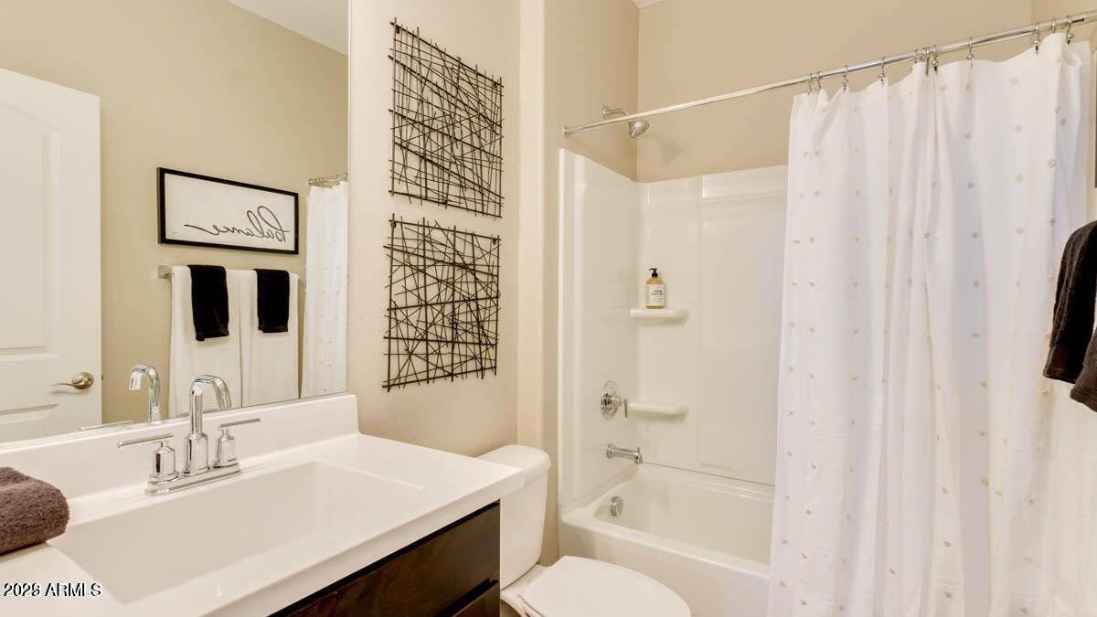 1255 North Arizona Avenue, Unit 1314 Chandler, AZ 85225 - Photo 13 of 23 a bathroom with a sink toilet a shower and a mirror