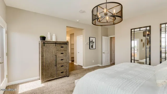 a bedroom with a bed and a chandelier