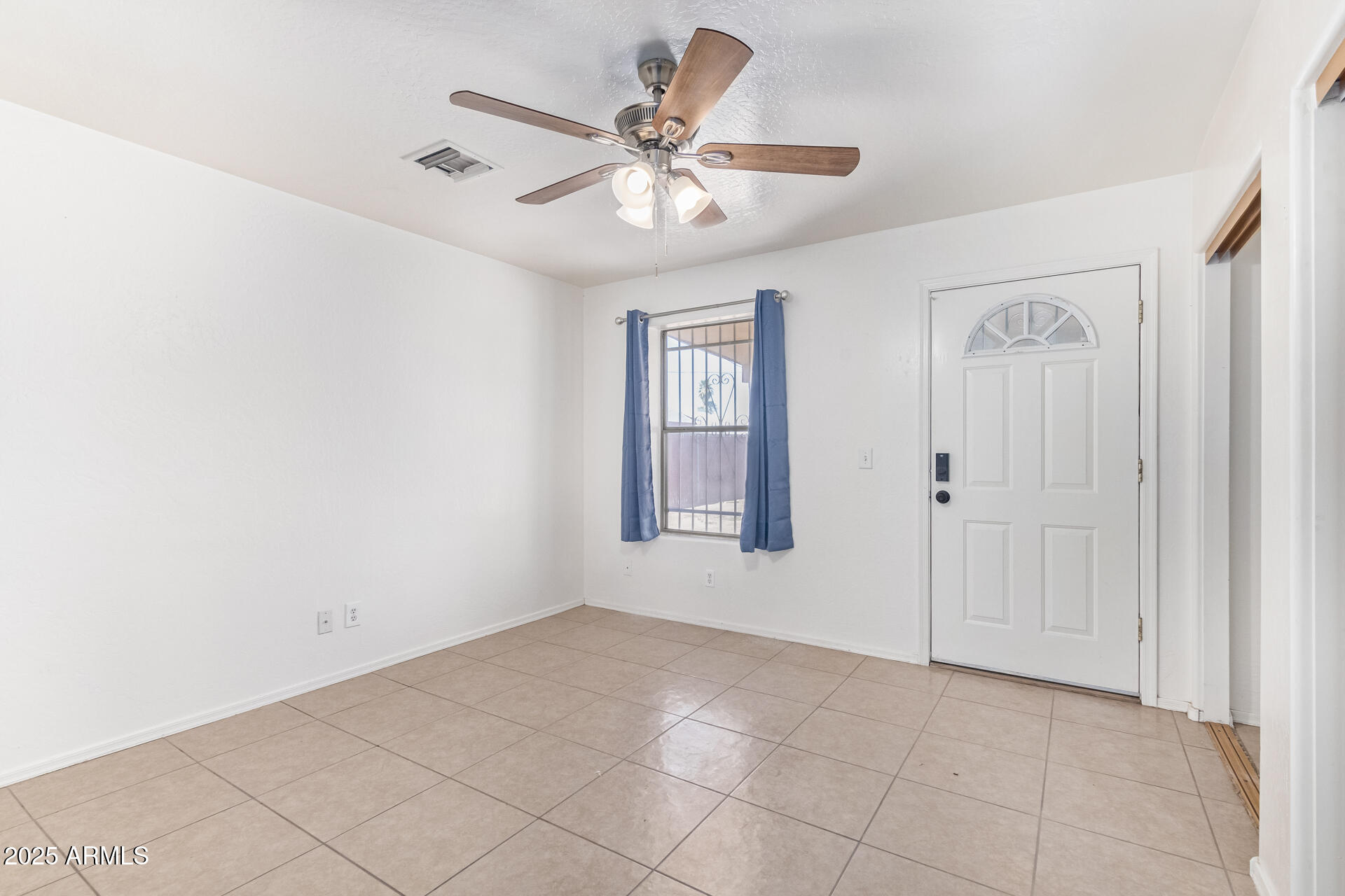 2118 West Adams Street Phoenix, AZ 85009 - Photo 12 of 48 a view of an empty room with a ceiling fan